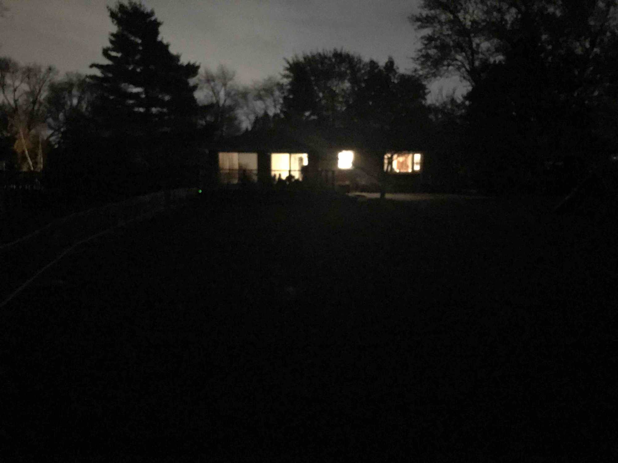 Dark yard with the house about 100ft away