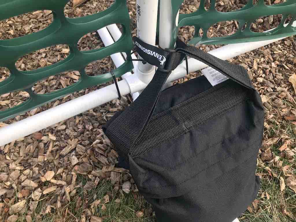 Velcro strap connecting gates and sandbag